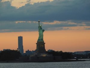 Sunset over NYC, showing Lady Liberty and sky line