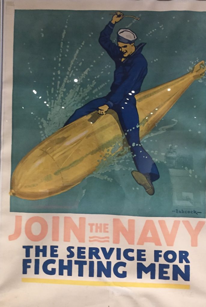 Join the Navy: The service for Fighting Men
showing a sailor on top of a torpedo