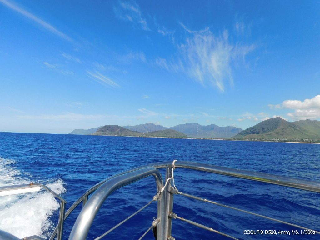 Looking out over the front of the boat, seeing the ocean and the Oahu coast. No dolphins yet. 