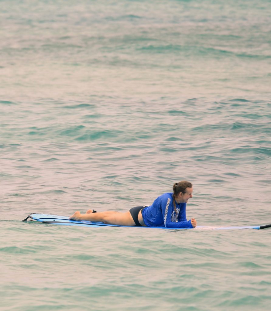 Karen relaxing on her surf board, looking out over Waikiki