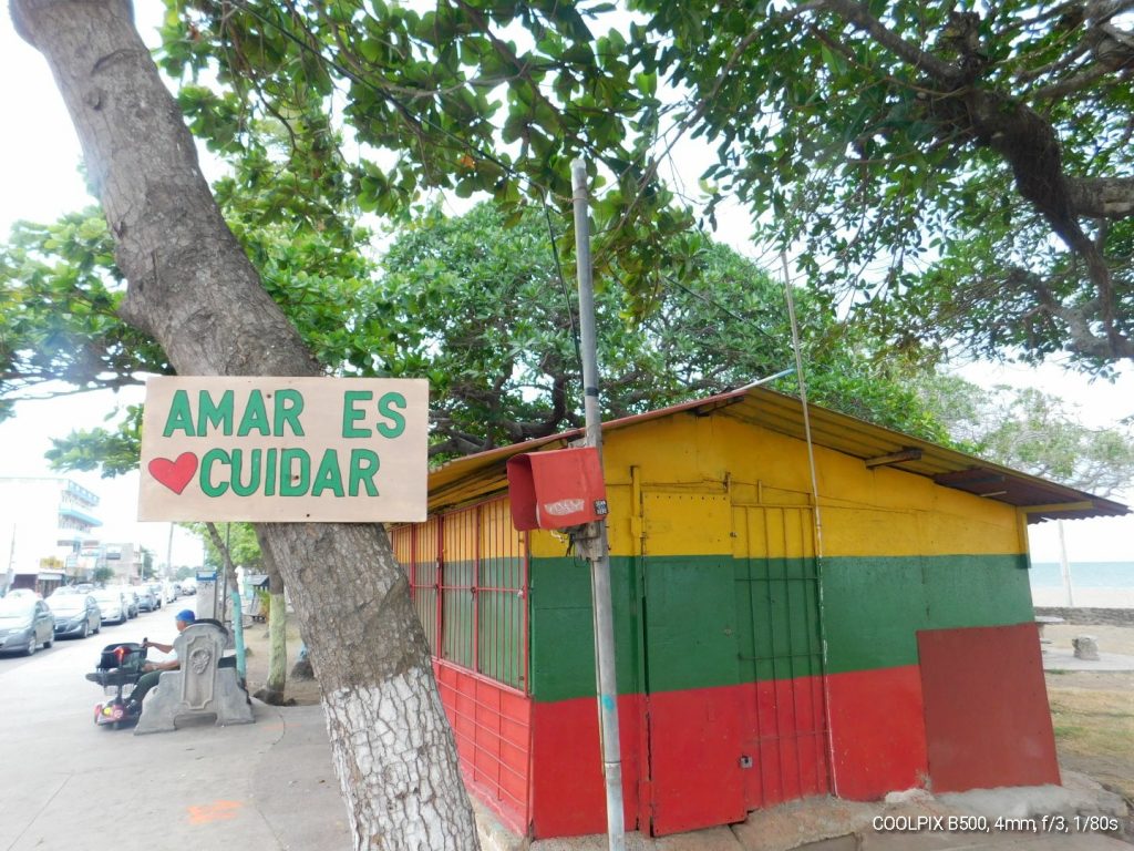 Multi colored building on the beach in Puntarenas with sign "Amar es Cuidar"
Loving is Caring.