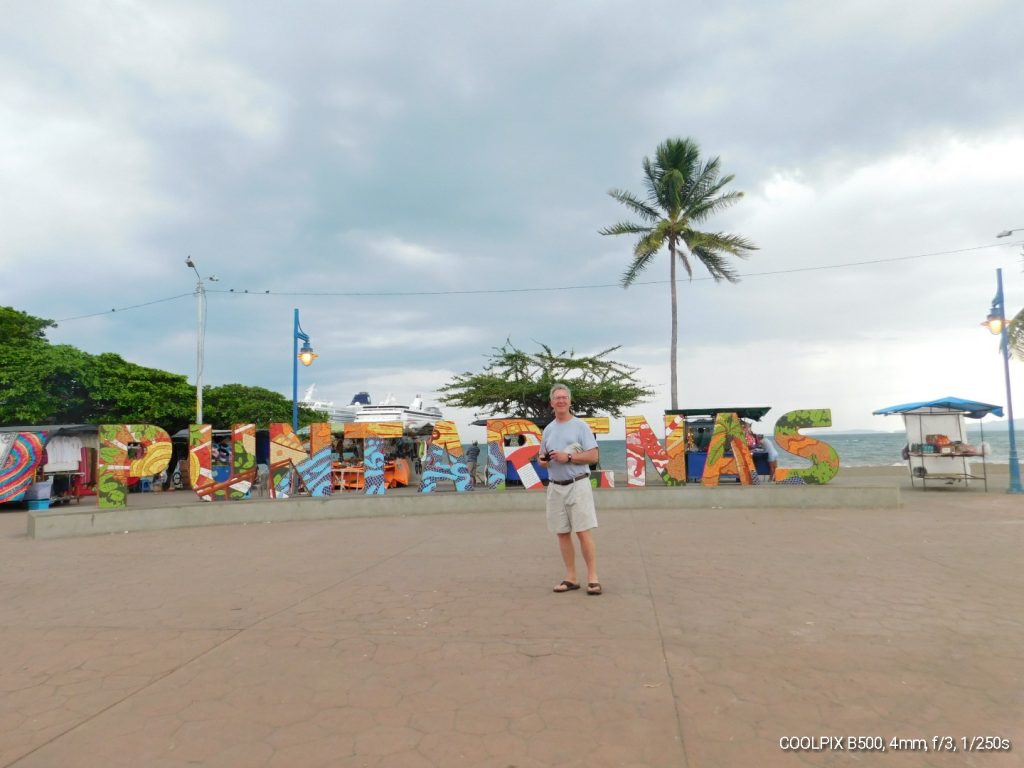 Tom in front of big PUNTARENAS letters on the beach in Costa Rica