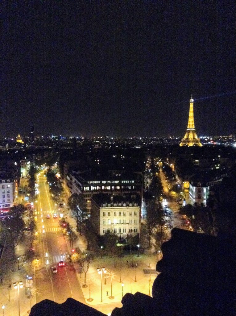 Paris by night. Lit up Eiffel Tower in the distance.
Spend your free weekend night in France!