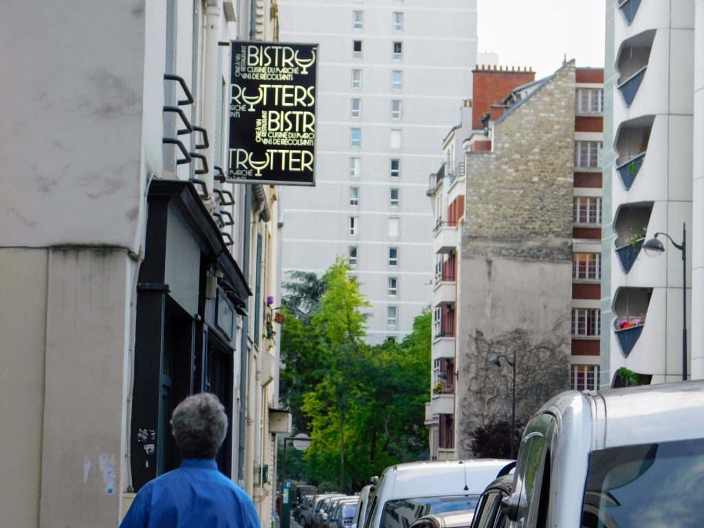 How to find good food in Paris that is affordable too. Showing a typical Paris street and the sign for Bistrotters