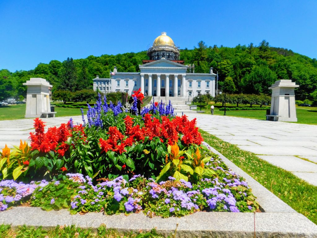 Vermont state house with flowers blooming in foreground