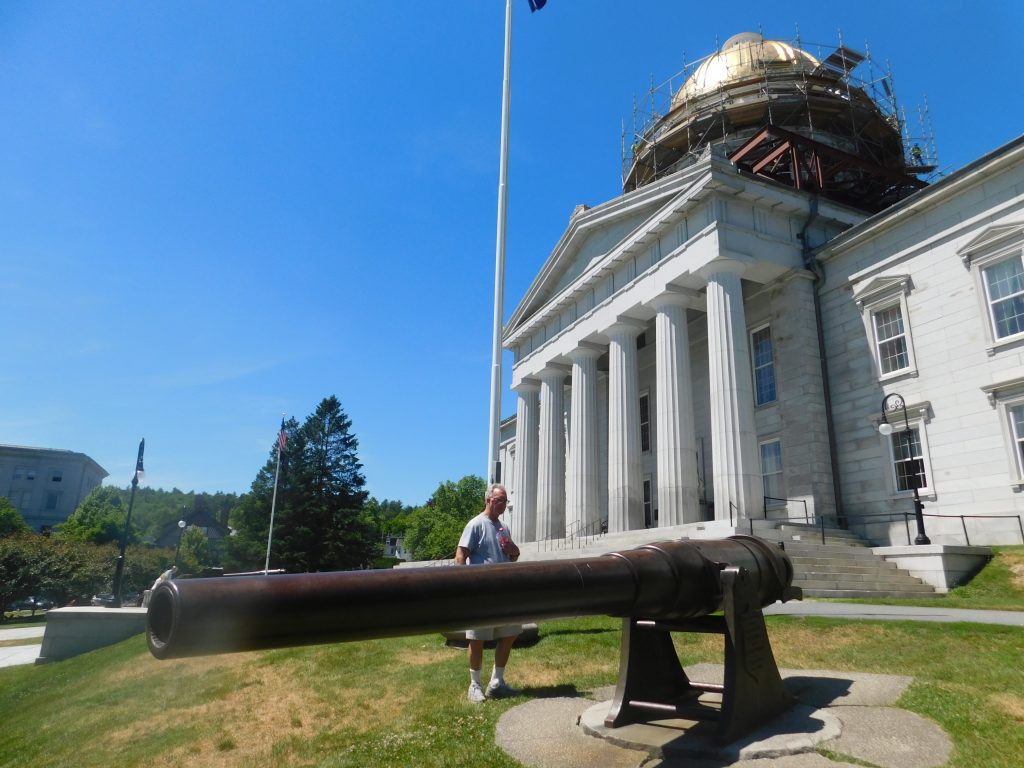 Big cannon in front of the Vermont state house with Tom standing next to it. 