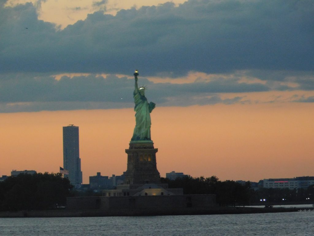 Sunset over NYC, showing Lady Liberty and sky line. Carpe Diem!