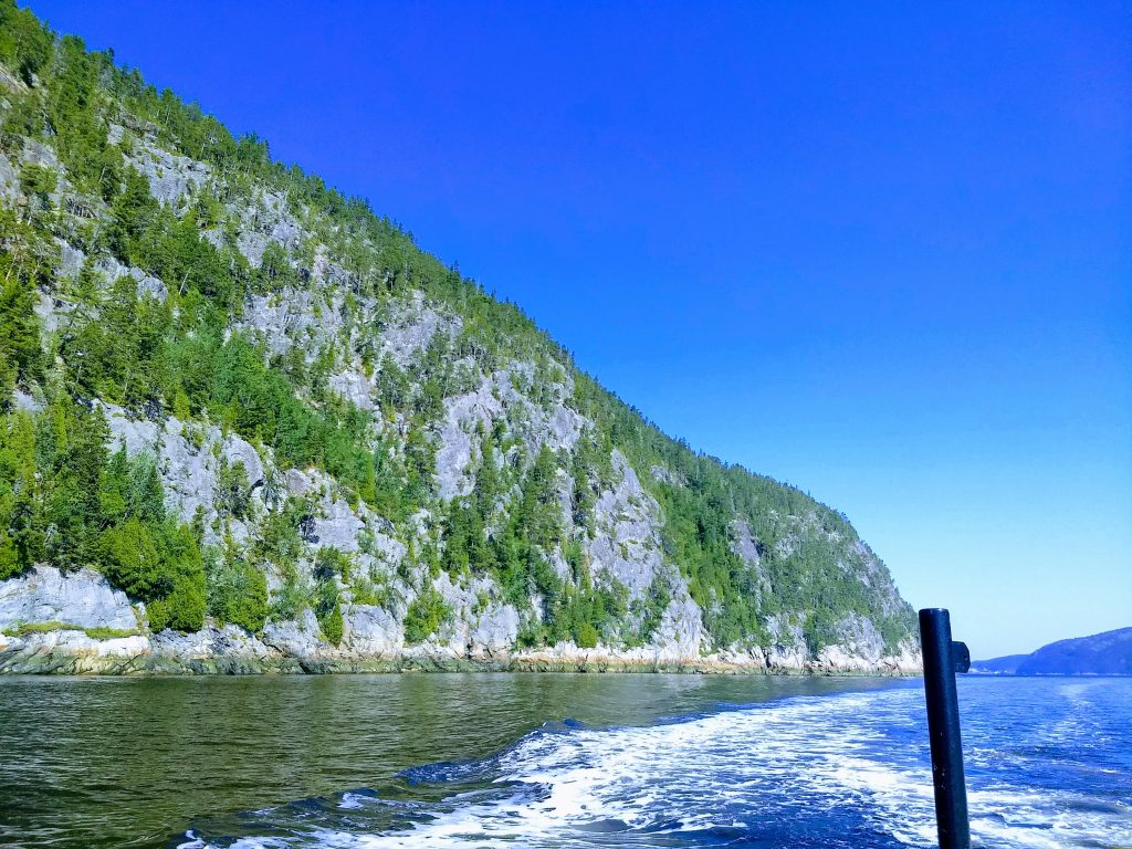 Water and a rocky, steep and high shore line. Entering the Saguenay Fjord on our way to watch seals on our whale watching cruise out of Quebec City