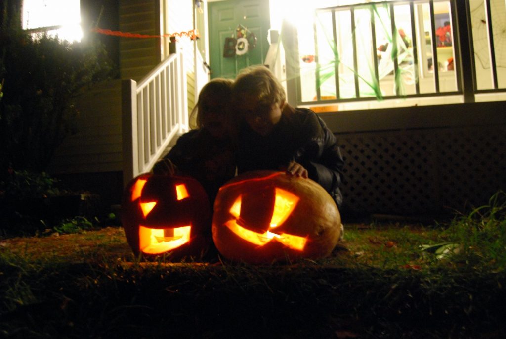 Two carved pumpkins with two kids at our front porch
Who doesn't fall with lots of family activities?