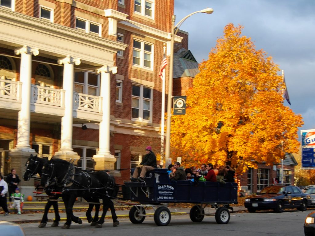 Wagon and horses hayride with yellow tree in background
Enjoy fall foliage in New England!