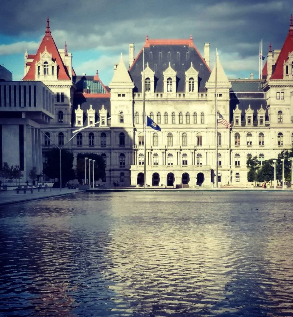 Beautiful New York Capitol building with pond in foreground