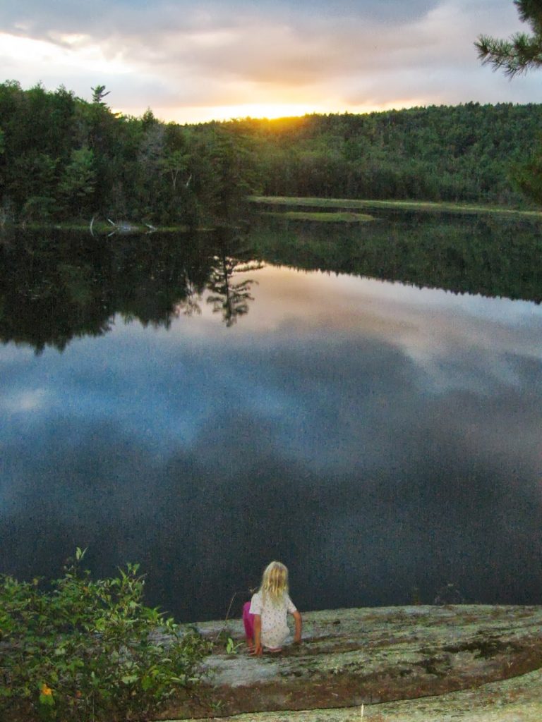 Watching the sunset over a pond. 
Great fall activity, but do realize that the sunset means that the rest of the hike is going to be in the dark...