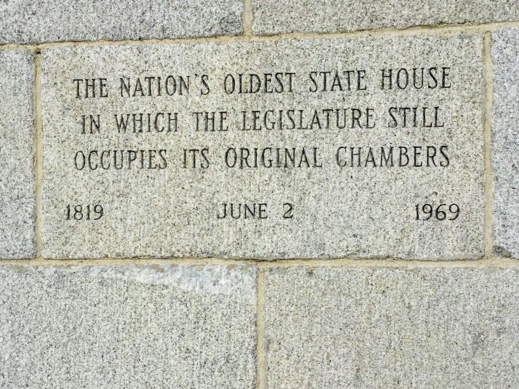 Plaque reading "the Nations's oldest state house in which the legislature still occupies its original chambers."