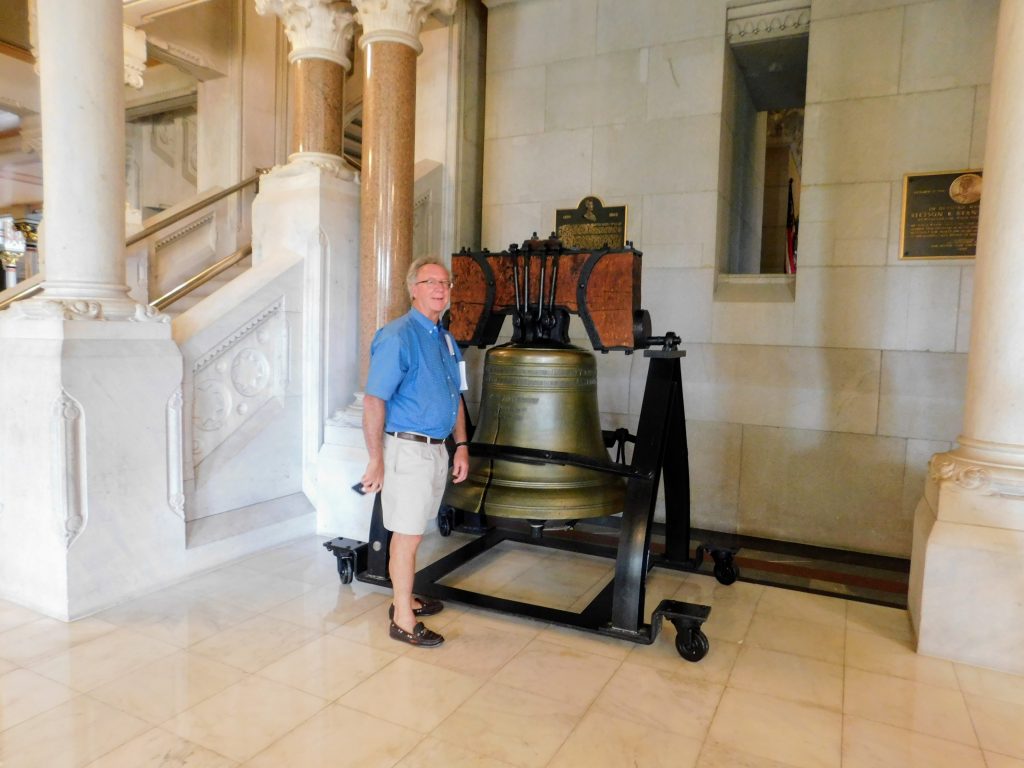 A Liberty Bell you can touch in Hartford CT. One of the surprising Connecticut Capitol Facts. Showing Tom next to the bell.