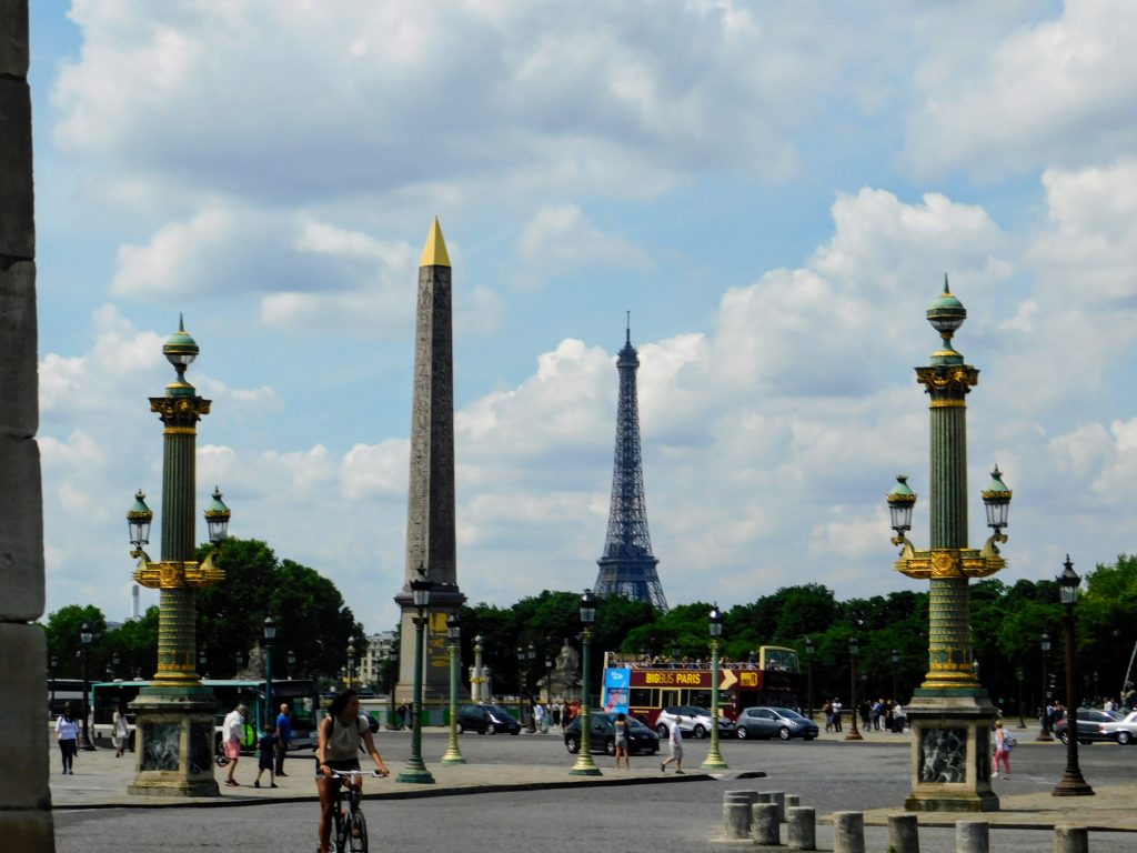 Paris landmarks, obelisk and Eiffel tower. Wander around Paris and enjoy instead of playing the cups and ball game. It is truly just yet another tourist scam. 