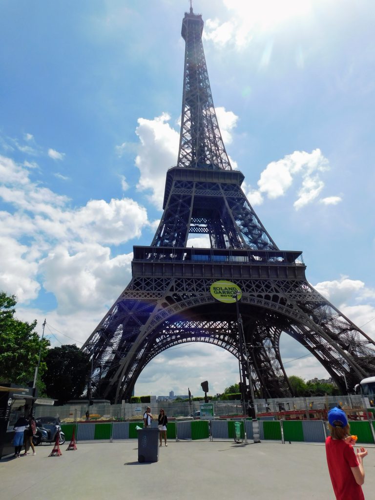 The Eiffel tower with beautiful cloudy sky behind it. We were on our way there when I found out that I could not beat the shell game and lost 50 Euros. A common tourist scam.