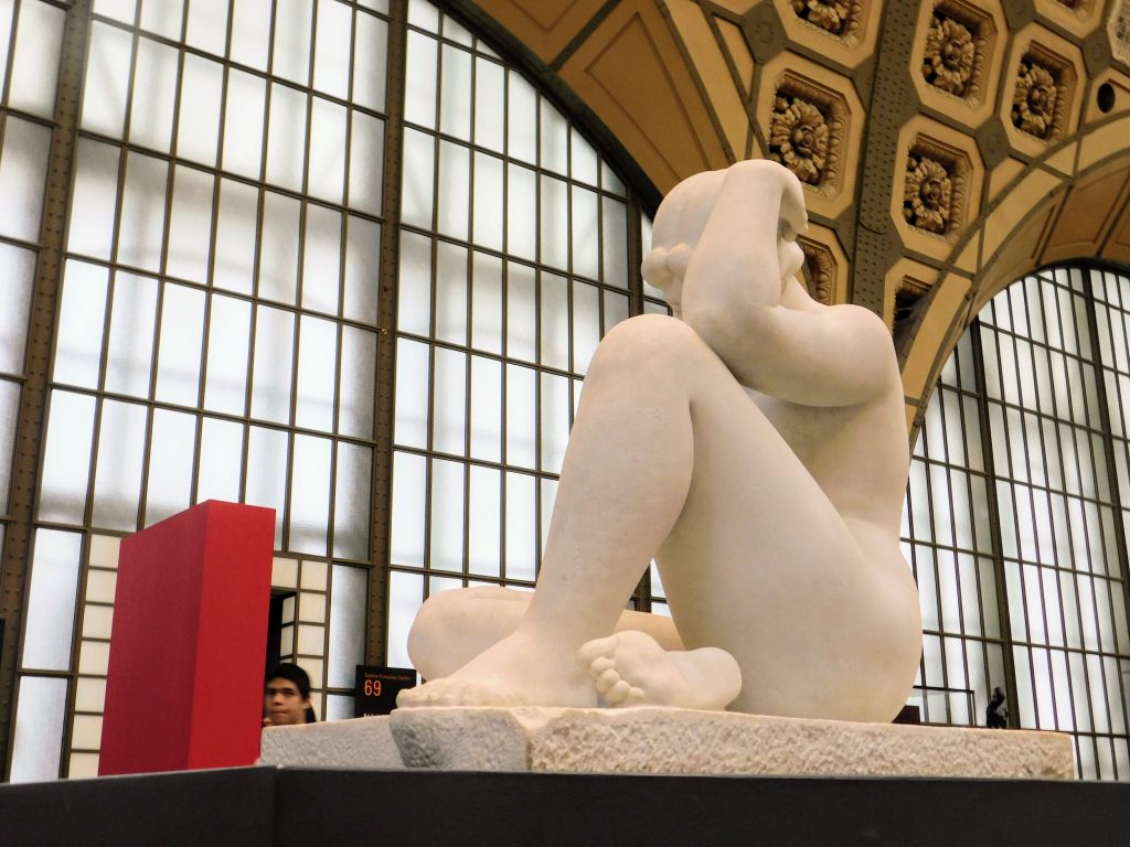 Sculpture in Musee d'Orsay, young woman sitting despondently and naked. Go visit the museum instead of participating in the shell game!