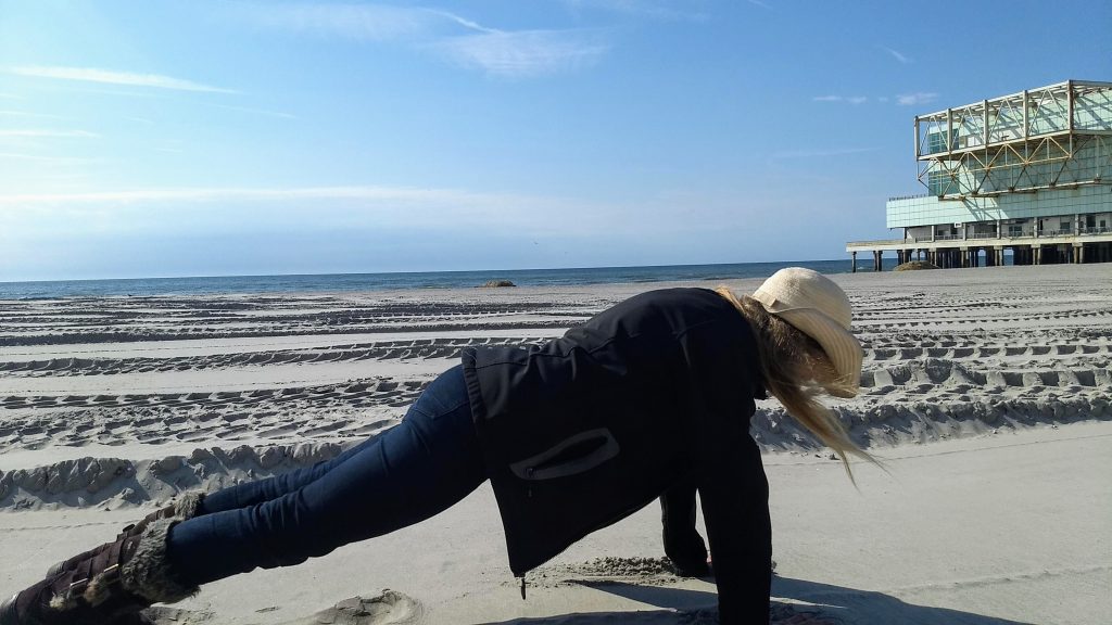 Karen planking on the beach in Atlantic City, performing her daily plank challenge. 