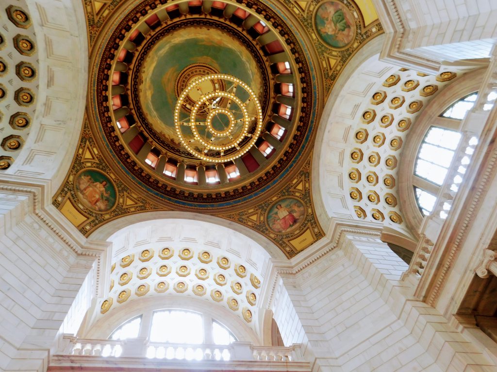 Looking up from the floor of the rotunda of the Rhode Island state house. You can see the chandelier and the interior of the huge dome. 