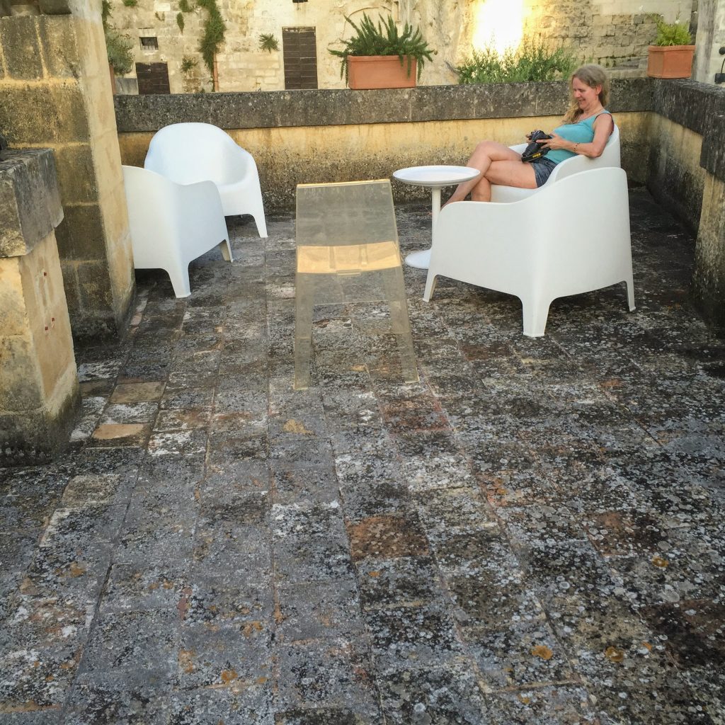 Karen on the roof terrace, checking her pictures of Matera. 