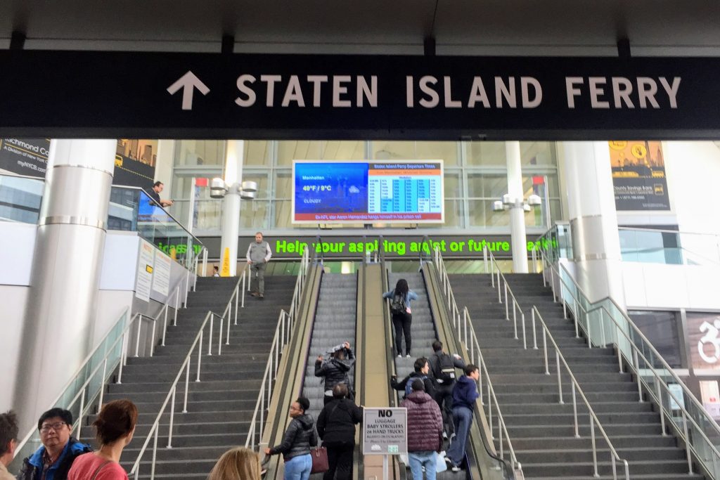 Interior of Staten Island Ferry Terminal, with escalators and stairs leading you to a free way of seeing the Statue of Liberty