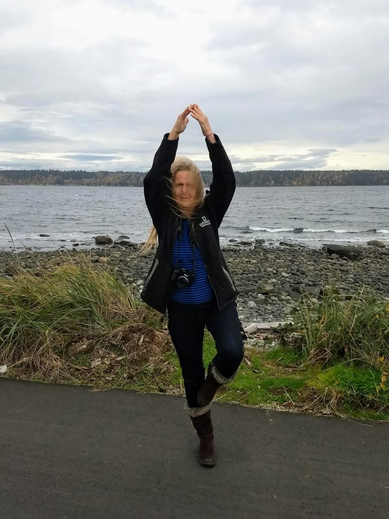 Karen doing a tree pose with choppy water behind her. This was in British Columbia. She has been working hard to get strong by doing exercises for MS