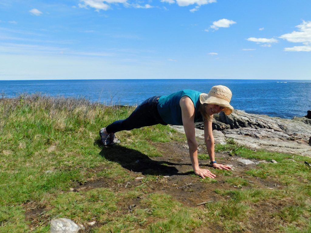 Karen doing push-ups in Maine, one of our summer destinations. One idea as featured in Momentum: short vacations close to home