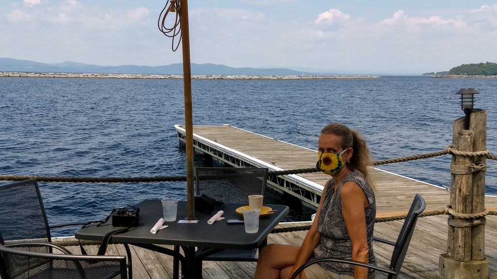 Karen having lunch with Lake Champlain in the background during our first travel to Vermont during Covid-19. 