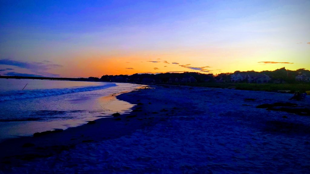 Sunset at Goose Rocks Beach. Surf rolling in to an empty beach.