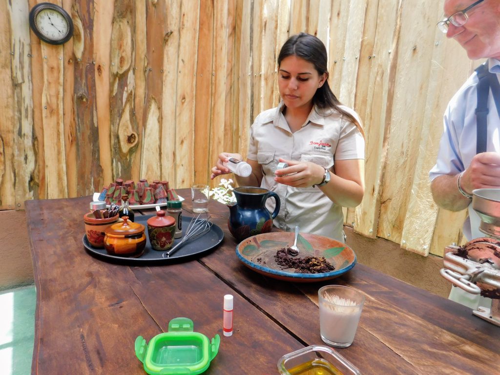 Our guide at a table where she demonstrates how to use the cocoa beans to make chocolate
at the Don Juan coffee plantation in Monteverde