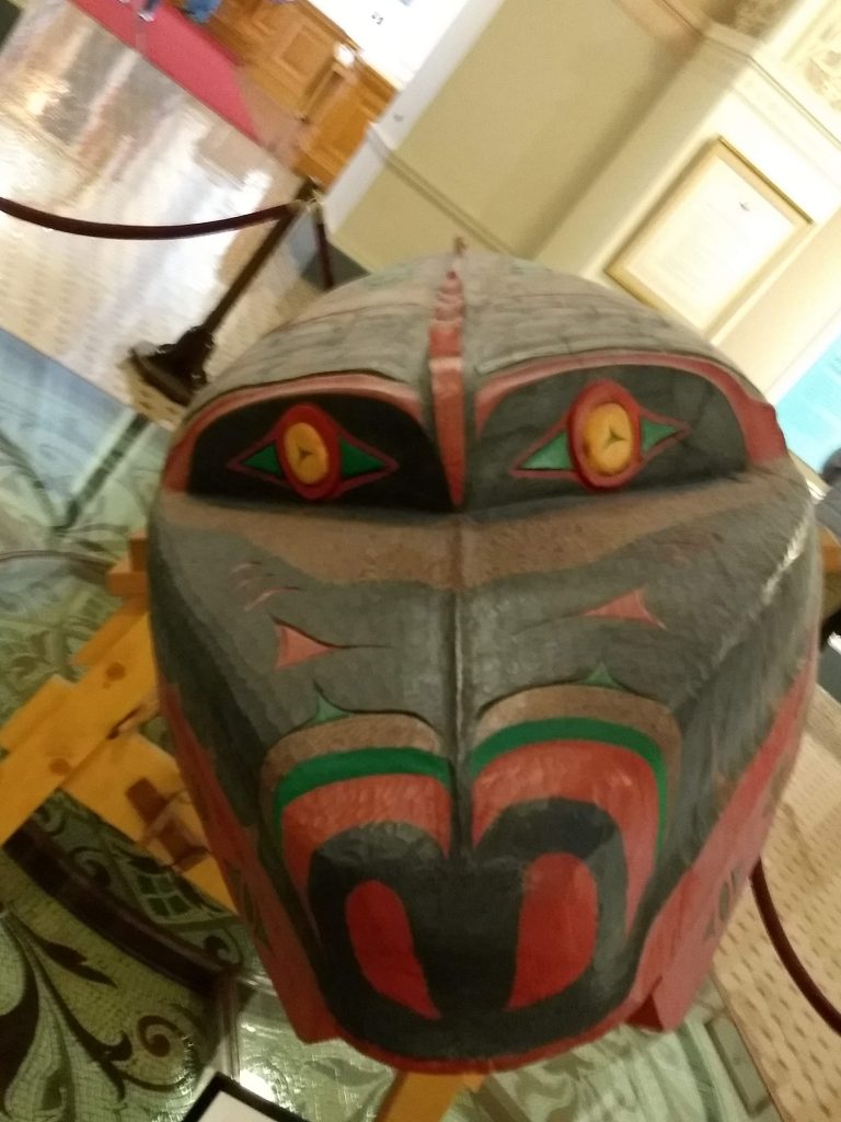 Front view of Shxwtitostel , a hand carved canoe in the Victoria BC Parliament building. 