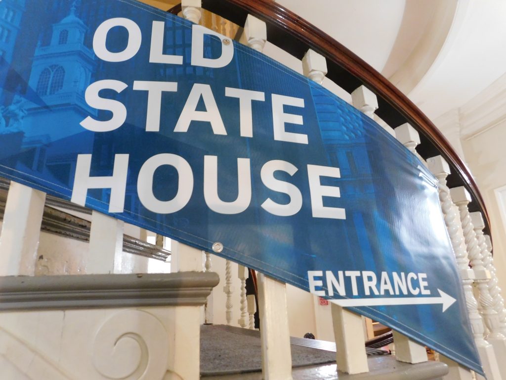 Old State House Entrance Sign on stair railings
