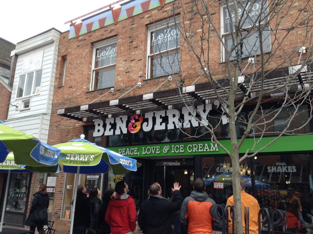 Make minimal money by shopping with Ibotta. People at a Ben and Jerry store.