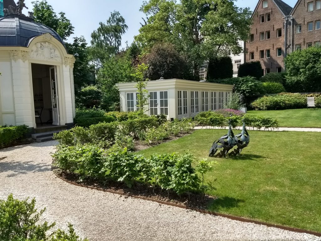 Waldorf Astoria Amsterdam Garden with tea house and peacock statues