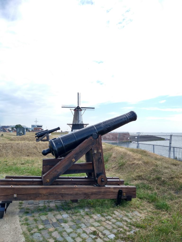 Canon at uncle beach in off the beaten path Zeeland Vlissingen with wind mill in background