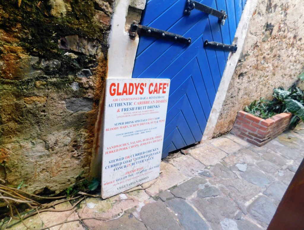 Gladys Cafe sign in front of blue door St Thomas
