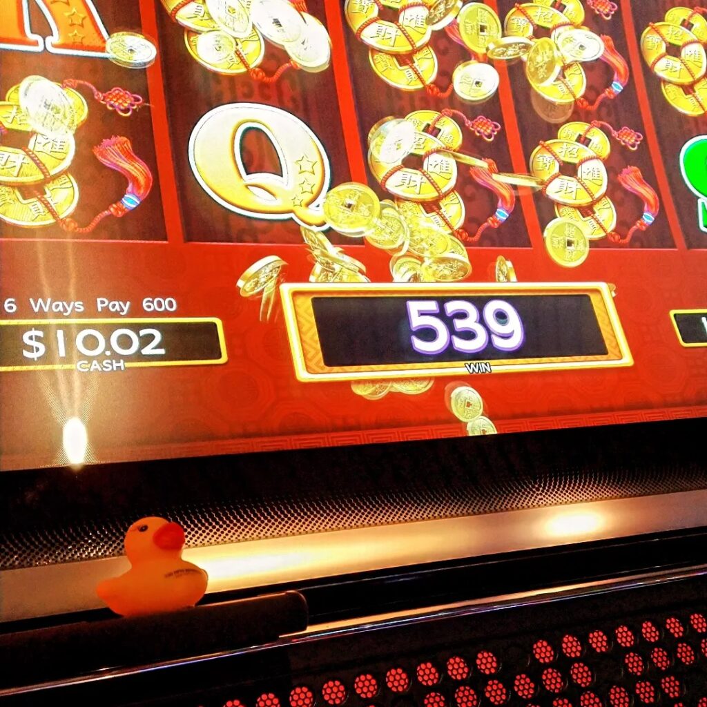 Kwek at casino slot machine in Alaska Flat Stanley photo