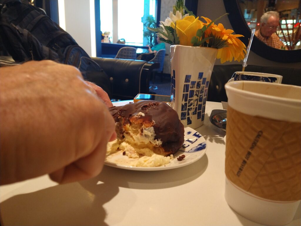 Eating a Bossche Bol in the Dutch Cafe on the MS Rotterdam